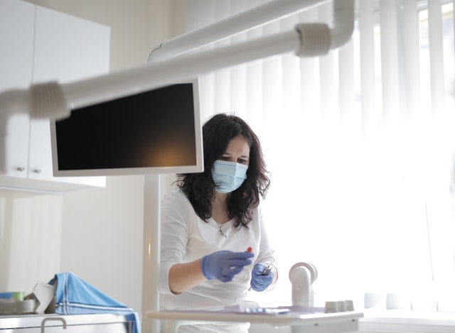 Photo by Andrea Piacquadio: https://www.pexels.com/photo/serious-female-dentist-preparing-medical-equipment-for-treatment-in-clinic-3881436/