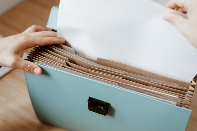 Photo by Anete Lusina: https://www.pexels.com/photo/person-taking-white-paper-from-folder-4792287/