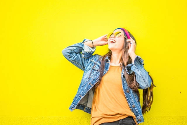 Photo by juan mendez: https://www.pexels.com/photo/smiling-woman-looking-upright-standing-against-yellow-wall-1536619/