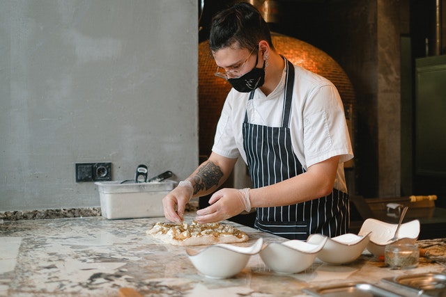 Photo by Anna Shvets: https://www.pexels.com/photo/a-chef-preparing-a-pizza-5953544/