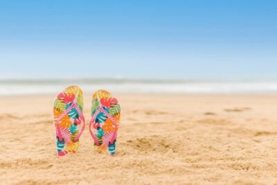 Photo by RODNAE Productions: https://www.pexels.com/photo/colorful-flip-flops-slipper-in-the-beach-san-8456247/