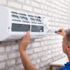 Adobe Stock royalty-free image #248121100, 'Technician Fixing Air Conditioner' uploaded by Andrey Popov, standard license purchased from https://stock.adobe.com/images/download/248121100; file retrieved on July 2nd, 2019. License details available at https://stock.adobe.com/license-terms - image is licensed under the Adobe Stock Standard License