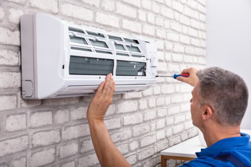Adobe Stock royalty-free image #248121100, 'Technician Fixing Air Conditioner' uploaded by Andrey Popov, standard license purchased from https://stock.adobe.com/images/download/248121100; file retrieved on July 2nd, 2019. License details available at https://stock.adobe.com/license-terms - image is licensed under the Adobe Stock Standard License