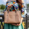 Photo by Artem Beliaikin: https://www.pexels.com/photo/photo-of-person-holding-brown-leather-handbag-2534961/