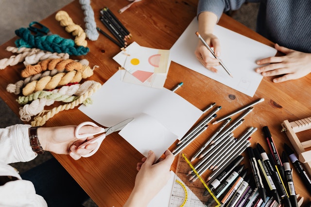 Photo by Karolina Grabowska: https://www.pexels.com/photo/photo-of-two-persons-drawing-and-cutting-a-white-paper-4219219/