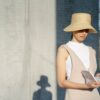 Photo by John Diez : https://www.pexels.com/photo/stylish-ethnic-woman-reading-book-in-sunny-town-7578497/