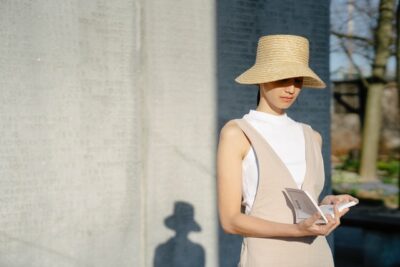 Photo by John Diez : https://www.pexels.com/photo/stylish-ethnic-woman-reading-book-in-sunny-town-7578497/