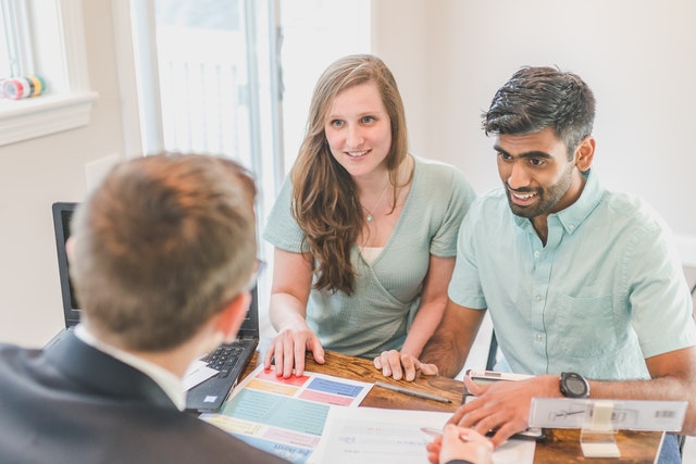 Photo by RODNAE Productions: https://www.pexels.com/photo/a-smiling-couple-talking-to-the-agent-8293775/