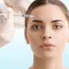 Adobe Stock royalty-free image #192860896, 'Woman at plastic surgery. Portrait of an attractive young woman receiving botox treatment. Isolated on light blue background.' uploaded by sepy, standard license purchased from https://stock.adobe.com/images/download/192860896; file retrieved on May 10th, 2019. License details available at https://stock.adobe.com/license-terms - image is licensed under the Adobe Stock Standard License