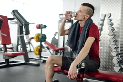 Photo by ShotPot: https://www.pexels.com/photo/man-in-black-and-red-crew-neck-t-shirt-sitting-on-black-and-red-exercise-equipment-4047244/