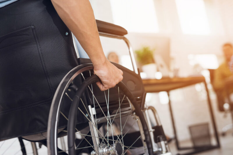 Adobe Stock royalty-free image #181562109, 'A disabled man is sitting in a wheelchair.' uploaded by VadimGuzhva, standard license purchased from https://stock.adobe.com/images/download/181562109; file retrieved on October 16th, 2019. License details available at https://stock.adobe.com/license-terms - image is licensed under the Adobe Stock Standard License