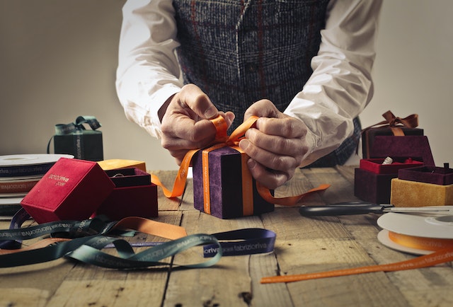 Photo by Andrea Piacquadio: https://www.pexels.com/photo/person-tying-ribbon-on-purple-gift-box-1050256/