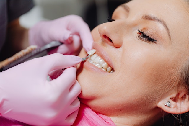 Photo by Karolina Grabowska: https://www.pexels.com/photo/a-dentist-applying-a-veneer-tooth-on-a-patient-6627571/