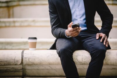 Photo by Ketut Subiyanto from Pexels: https://www.pexels.com/photo/crop-businessman-using-smartphone-while-resting-on-bench-with-takeaway-coffee-4560134/