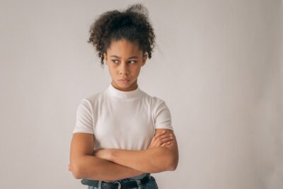 Photo by Monstera: https://www.pexels.com/photo/anxious-black-girl-with-crossed-arms-7114724/