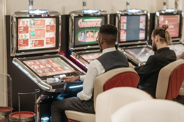 Photo by Pavel Danilyuk: https://www.pexels.com/photo/men-sitting-in-front-of-a-slot-machine-7594264/
