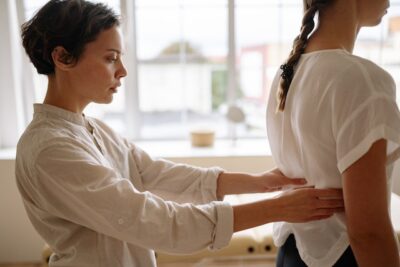 Photo by Yan Krukov: https://www.pexels.com/photo/physiotherapist-touching-womans-back-5793653/