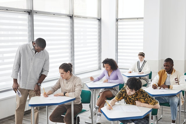Photo by Andy Barbour: https://www.pexels.com/photo/a-man-looking-at-his-students-while-taking-exam-6683578/