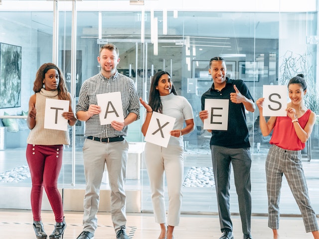 Photo by Kindel Media: https://www.pexels.com/photo/a-group-of-people-holding-papers-with-printed-taxes-7688519/