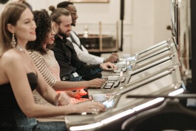 Photo by Pavel Danilyuk: https://www.pexels.com/photo/people-playing-slot-machines-7594252/