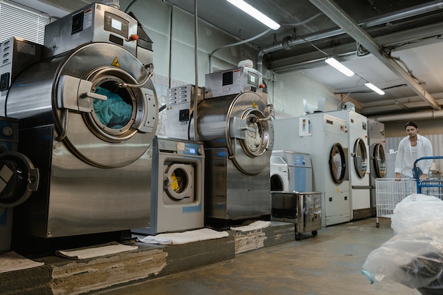 Photo by Tima Miroshnichenko: https://www.pexels.com/photo/man-pushing-basket-trolley-near-big-washing-machines-8774645/