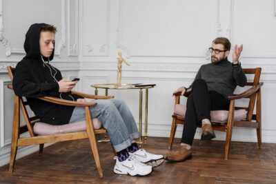 Photo by cottonbro studio: https://www.pexels.com/photo/man-in-black-sweater-and-blue-denim-jeans-sitting-on-brown-wooden-rocking-chair-4100486/