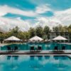 Photo by Donald Tong: https://www.pexels.com/photo/black-outdoor-lounge-chair-in-between-blue-swimming-pool-under-white-cloudy-blue-sky-189296/