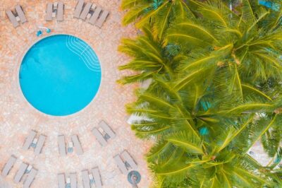 Photo by Jess Loiterton: https://www.pexels.com/photo/sunbeds-arranged-around-circular-swimming-pool-4784478/