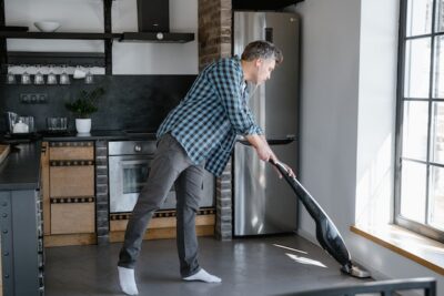 Photo by MART PRODUCTION: https://www.pexels.com/photo/a-man-in-plaid-shirt-and-denim-jeans-cleaning-the-kitchen-floor-7641490/