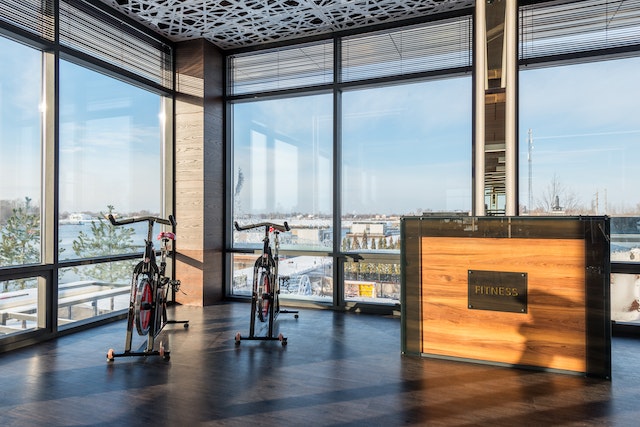 Photo by Max Vakhtbovych: https://www.pexels.com/photo/fitness-machines-and-reception-desk-in-modern-sports-club-7031717/