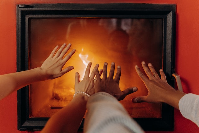Photo by Mikhail Nilov: https://www.pexels.com/photo/couples-hands-by-fireplace-6530539/