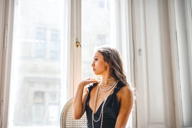 Photo by Andrea Piacquadio: https://www.pexels.com/photo/woman-in-black-sleeveless-dress-standing-beside-white-framed-glass-window-3765163/