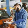 Photo by Gustavo Fring: https://www.pexels.com/photo/smiling-man-in-blue-coveralls-standing-beside-an-orange-car-having-conversation-over-the-phone-6870324/