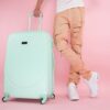 Photo by Kindel Media: https://www.pexels.com/photo/person-wearing-brown-pants-standing-beside-a-green-suitcase-8212233/