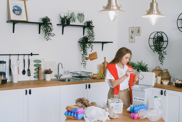 Photo by SHVETS production: https://www.pexels.com/photo/young-woman-utilizing-wastes-in-modern-kitchen-7512869/