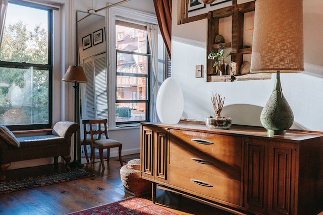 Photo by Charlotte May: https://www.pexels.com/photo/elegant-table-lamps-placed-on-wooden-cabinet-in-stylish-room-with-windows-in-sunlight-5824527/