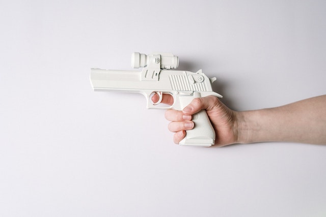 Photo by cottonbro studio: https://www.pexels.com/photo/person-holding-white-and-gray-semi-automatic-pistol-3926743/