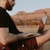 Photo by Dziana Hasanbekava: https://www.pexels.com/photo/thoughtful-man-with-laptop-in-countryside-5589356/