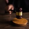 Photo by EKATERINA BOLOVTSOVA: https://www.pexels.com/photo/brown-wooden-gavel-on-brown-wooden-table-6077326/