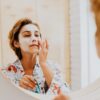 Photo by Karolina Grabowska: https://www.pexels.com/photo/woman-applying-facial-mask-on-her-face-in-front-of-a-mirror-5240446/
